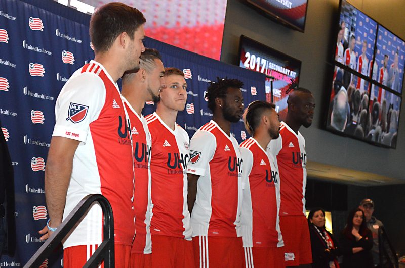 (Left to Right): Revolution players Kelyn Rowe, Diego Fagundez, Scott Caldwell, Xavier Kouassi, Lee Nguyen, and Kei Kamara model the New England Revolution’s new secondary kit at the official unveiling at Gillette Stadium. Photo: Steve Spencer.